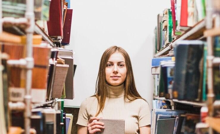 back-school-concept-with-woman-studying-library_23-2148172335